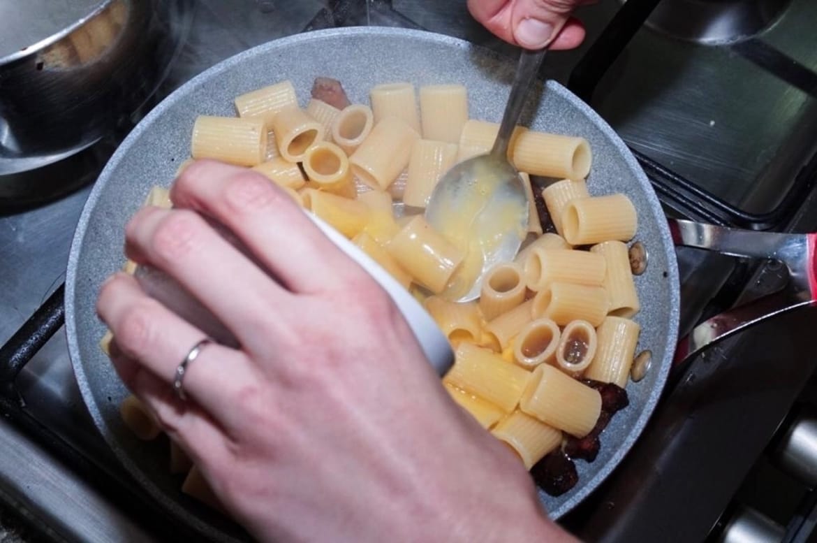 Adding Pecorino Cheese to the Carbonara